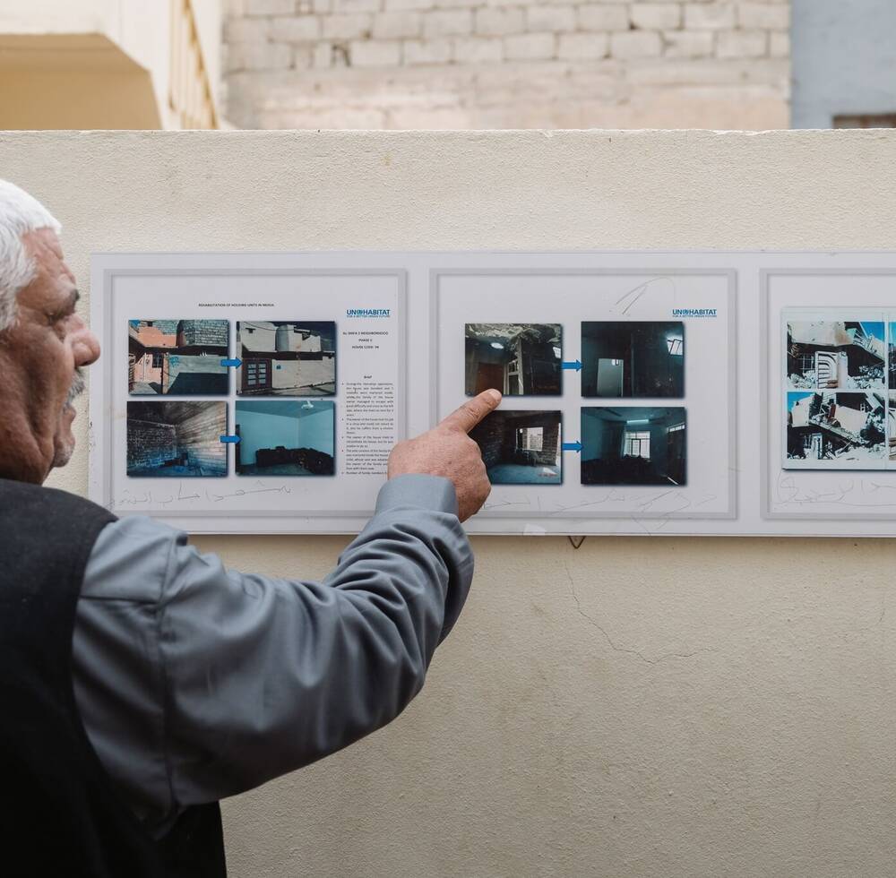 Photo of a beneficiary explaining UN-Habitat's rehabilitation plans in Mosul